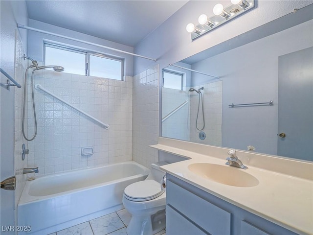 full bathroom featuring vanity, tiled shower / bath, and toilet