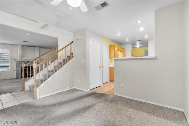 carpeted spare room featuring ceiling fan