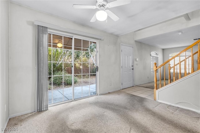 interior space featuring light carpet and ceiling fan