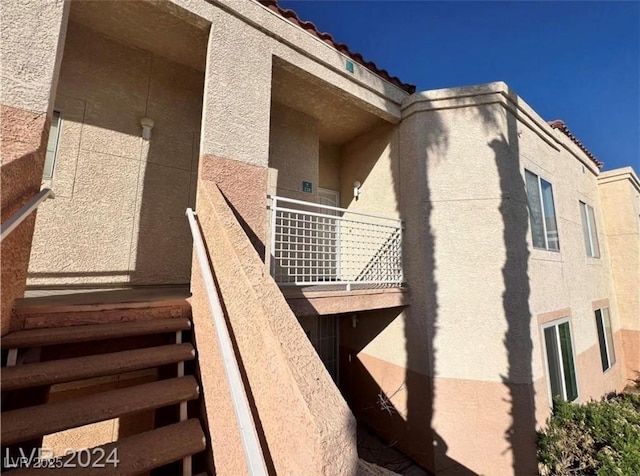 view of side of home with a balcony