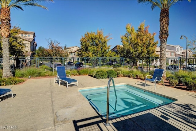 view of swimming pool with a patio area and a community hot tub