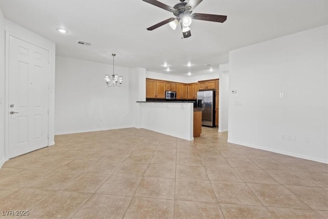 unfurnished living room with ceiling fan with notable chandelier and light tile patterned floors