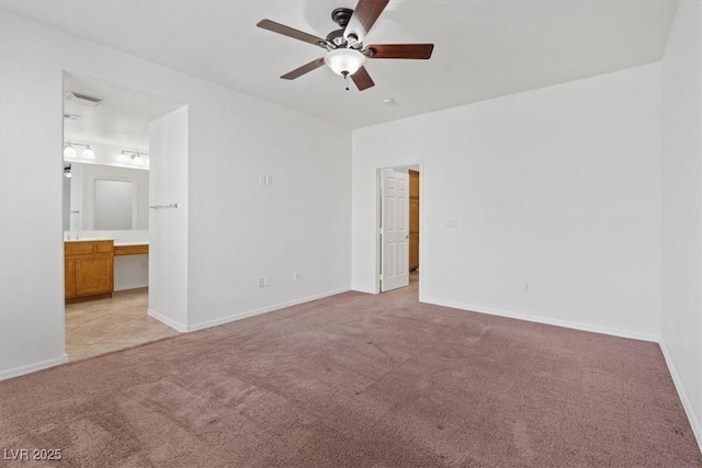 unfurnished bedroom featuring ceiling fan, connected bathroom, and light carpet