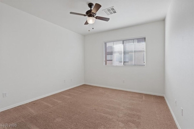 spare room with ceiling fan and carpet