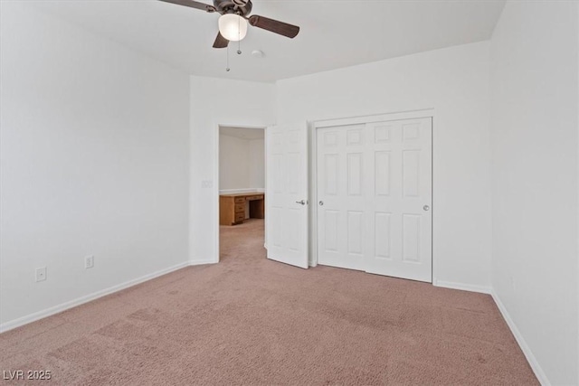 unfurnished bedroom with carpet floors, a closet, and ceiling fan