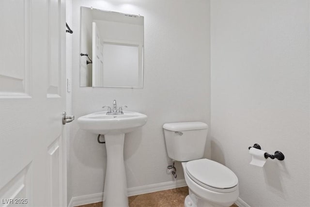 bathroom with toilet and tile patterned flooring