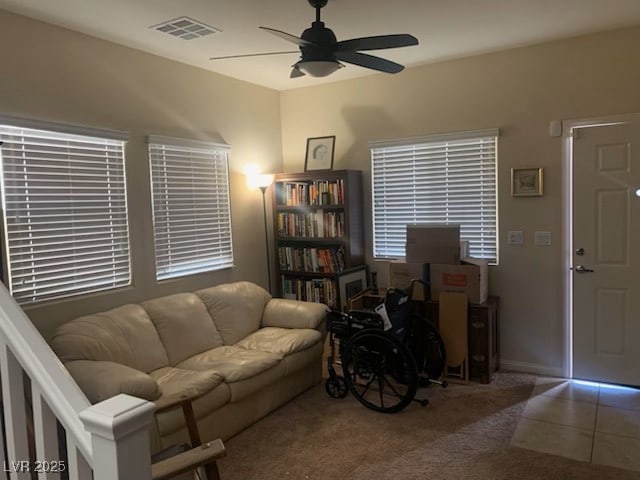 carpeted living room with ceiling fan