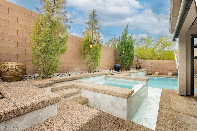 view of swimming pool with an in ground hot tub