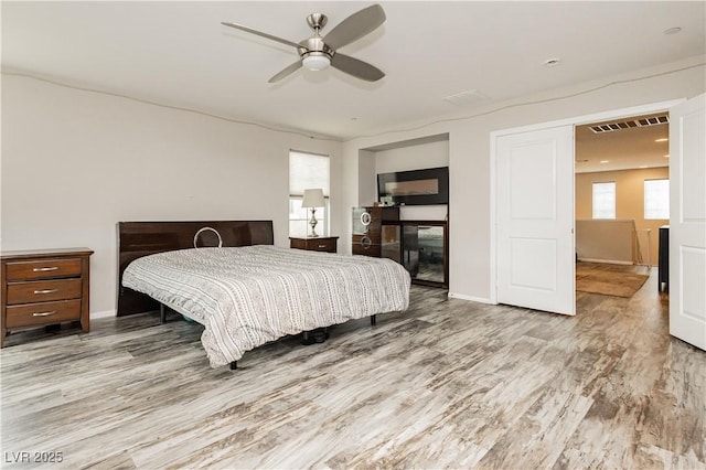 bedroom with ceiling fan and light wood-type flooring