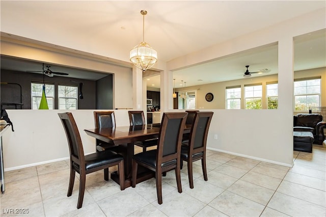 dining area featuring ceiling fan with notable chandelier and light tile patterned floors