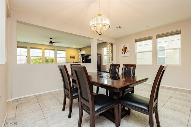 dining space featuring ceiling fan with notable chandelier and light tile patterned flooring