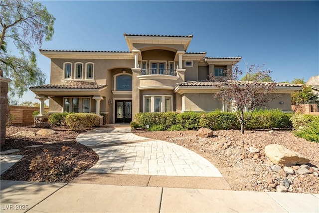 mediterranean / spanish home featuring a balcony