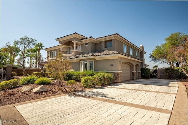 mediterranean / spanish house featuring a garage and a balcony