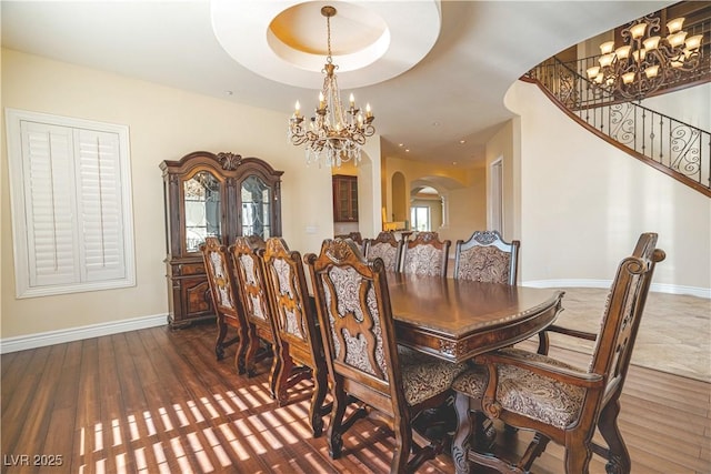 dining area featuring dark wood-type flooring and a notable chandelier