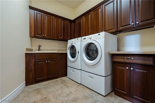 laundry area featuring sink, cabinets, and independent washer and dryer