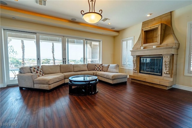 living room featuring dark wood-type flooring and a fireplace