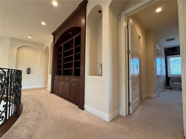 hallway with light colored carpet