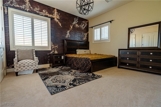 bedroom with brick wall and light carpet