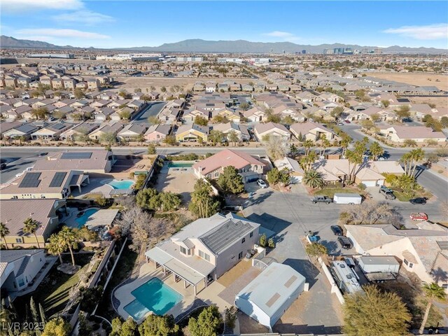 9435 Westwind Rd, Las Vegas, NV 89139 - aerial view of property's location featuring a pool, nearby suburban area, and a mountainous background