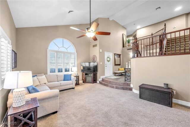 9435 Westwind Rd, Las Vegas, NV 89139 - living room with high vaulted ceiling, stairway, ceiling fan, carpet flooring, and beamed ceiling
