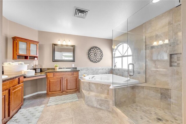 9435 Westwind Rd, Las Vegas, NV 89139 - full bathroom with vanity, a garden tub, tile patterned flooring, and a stall shower