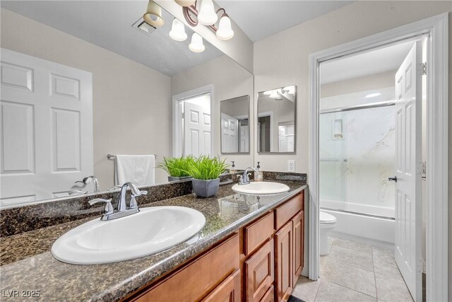 9435 Westwind Rd, Las Vegas, NV 89139 - full bath featuring toilet, double vanity, bath / shower combo with glass door, and tile patterned floors
