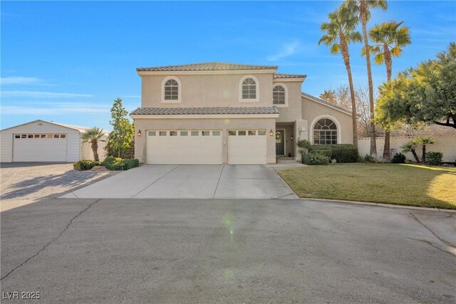 9435 Westwind Rd, Las Vegas, NV 89139 - mediterranean / spanish-style home featuring stucco siding, concrete driveway, a tile roof, and a front lawn