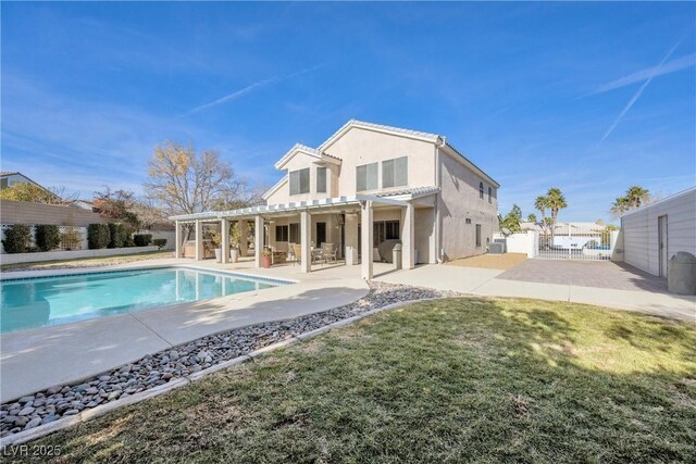 9435 Westwind Rd, Las Vegas, NV 89139 - rear view of house featuring a pergola, a patio area, stucco siding, and a gate