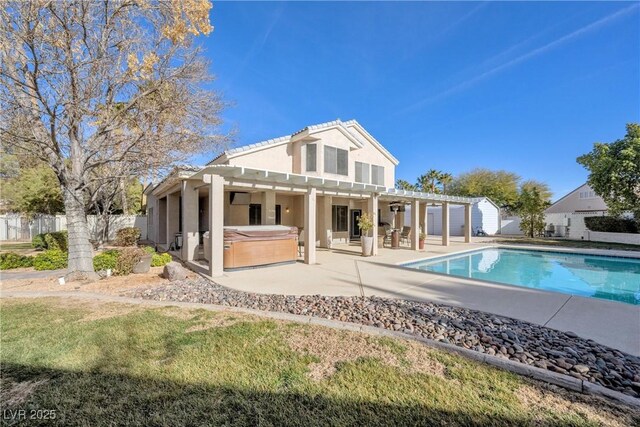 9435 Westwind Rd, Las Vegas, NV 89139 - back of house featuring a hot tub, stucco siding, a pergola, a patio area, and fence