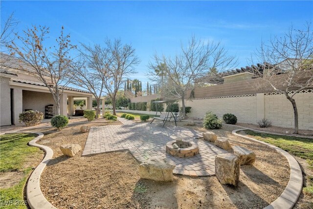 9435 Westwind Rd, Las Vegas, NV 89139 - fenced backyard featuring a patio area and a fire pit