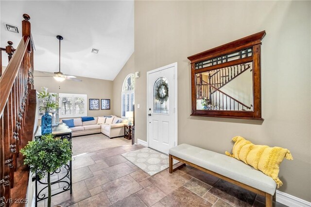 9435 Westwind Rd, Las Vegas, NV 89139 - entrance foyer featuring baseboards, high vaulted ceiling, stone finish floors, stairway, and a ceiling fan