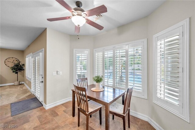 9435 Westwind Rd, Las Vegas, NV 89139 - dining area featuring a ceiling fan, baseboards, and light stone finish floors