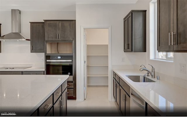 kitchen featuring sink, black appliances, light stone countertops, dark brown cabinets, and wall chimney exhaust hood