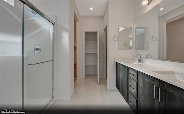 bathroom with vanity, tile patterned flooring, and walk in shower