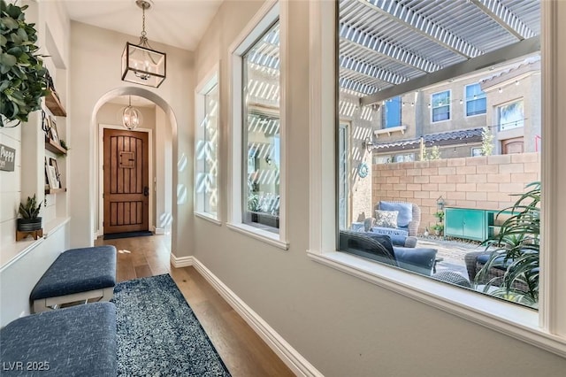 interior space with wood-type flooring and a notable chandelier