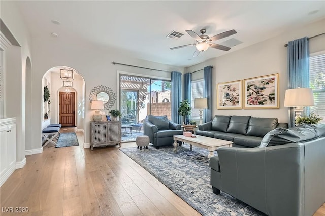 living room with light hardwood / wood-style flooring and ceiling fan