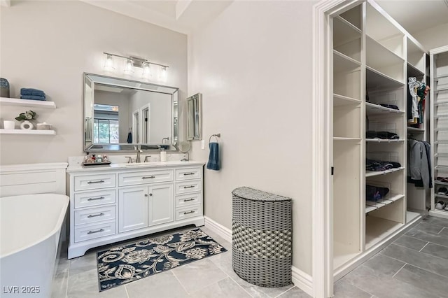 bathroom with vanity, tile patterned flooring, and a bathtub