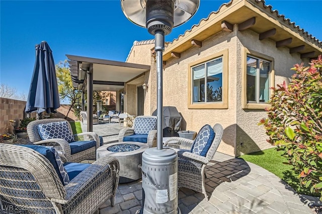 view of patio featuring an outdoor living space with a fire pit