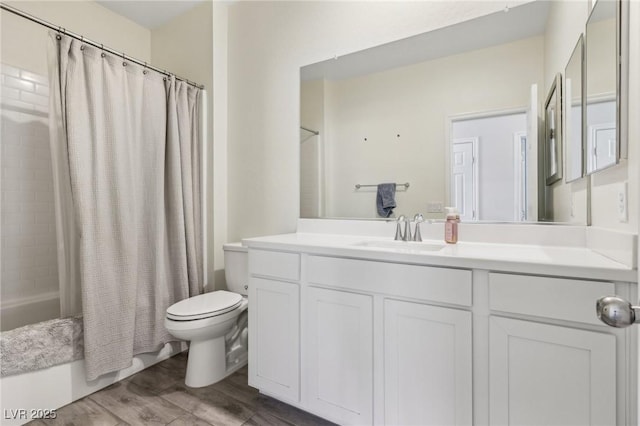 full bathroom featuring vanity, toilet, hardwood / wood-style floors, and shower / bath combo with shower curtain