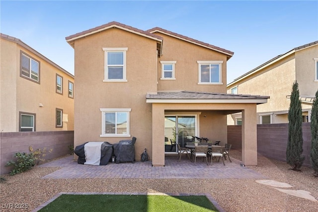 rear view of property featuring a patio