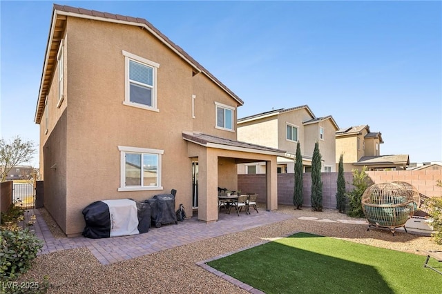 rear view of house featuring a patio