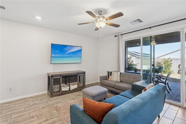 living room featuring ceiling fan and light wood-type flooring