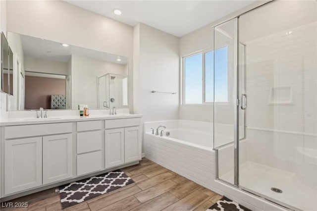 bathroom featuring vanity and independent shower and bath