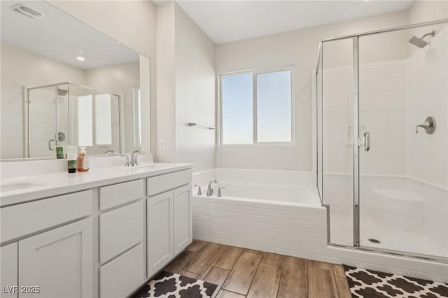 bathroom with shower with separate bathtub and vanity