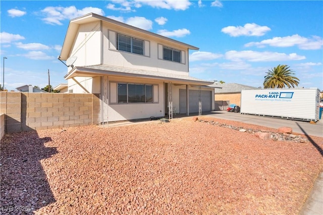 rear view of property with a garage