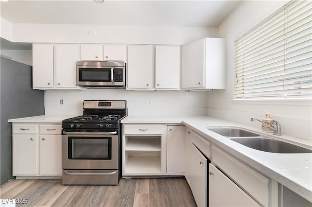 kitchen featuring white cabinetry, stainless steel appliances, and sink