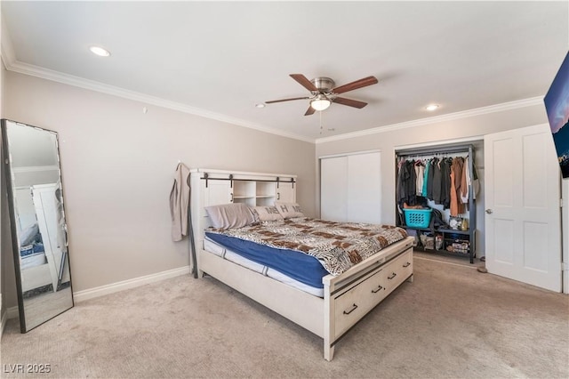 carpeted bedroom with multiple closets, ceiling fan, and ornamental molding