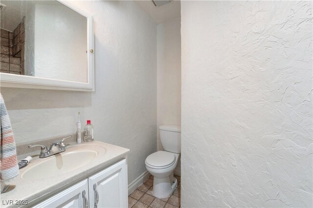 bathroom featuring vanity, tile patterned flooring, and toilet