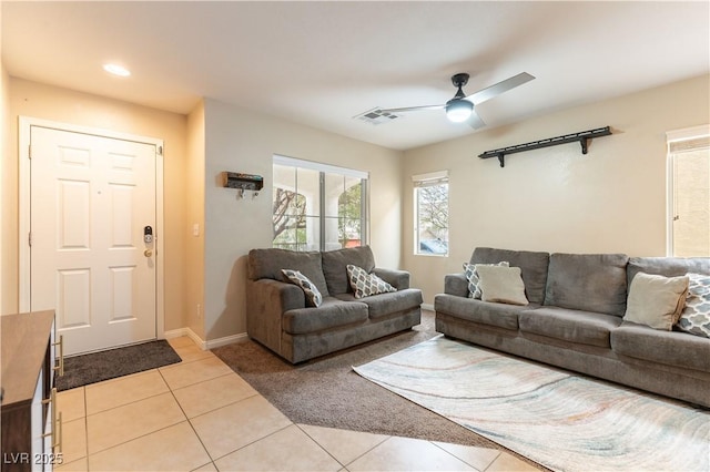 living room featuring baseboards, visible vents, a ceiling fan, and light tile patterned flooring