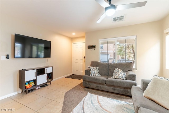 living room with visible vents, ceiling fan, baseboards, and light tile patterned floors